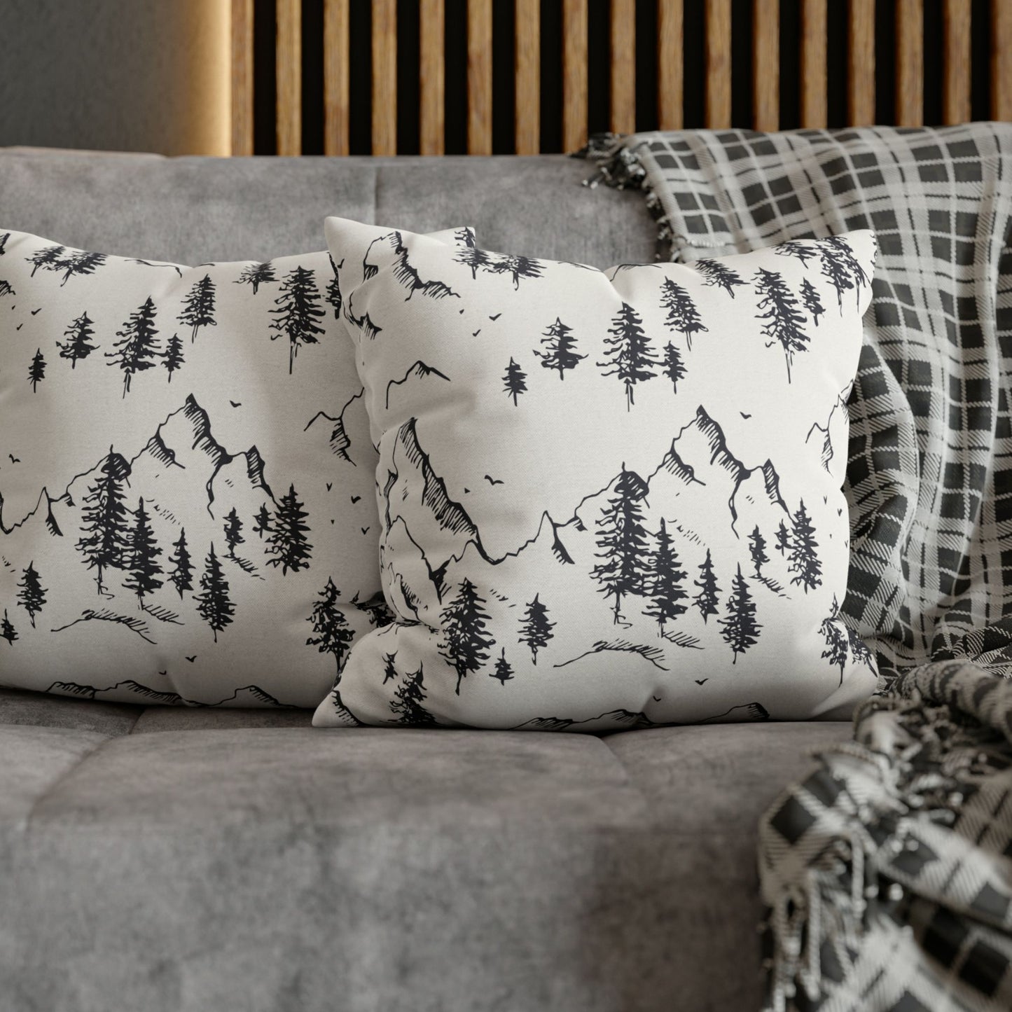 2 Minimalist Winter Tree decorative pillows from Blue Water Songs on grey sofa