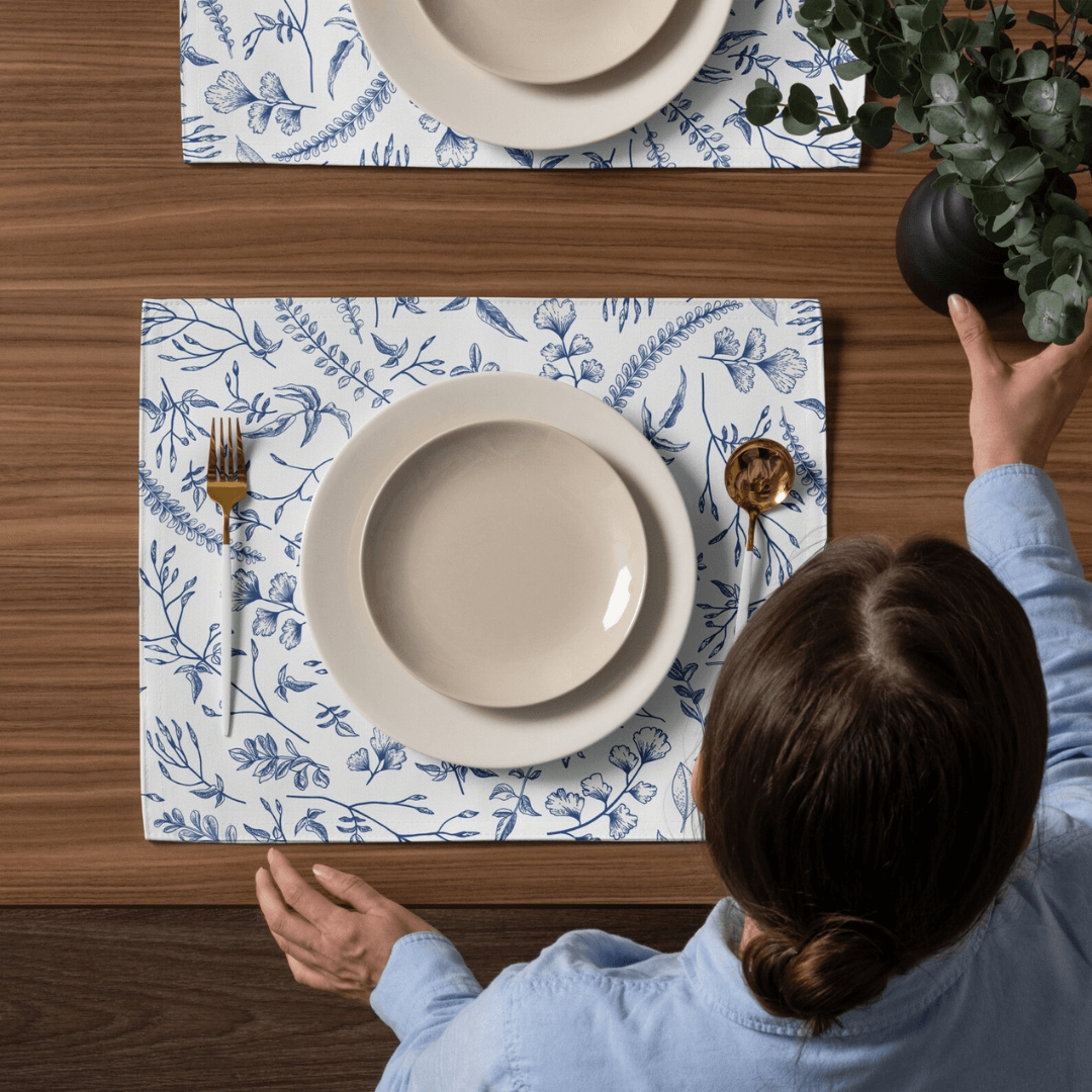 woman arrange dinning table with placemats and white plates