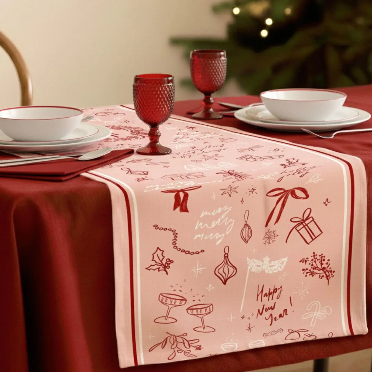 Blush Pink Christmas Table Runner with red line art, perfect for festive holiday decor and cozy dinners.
