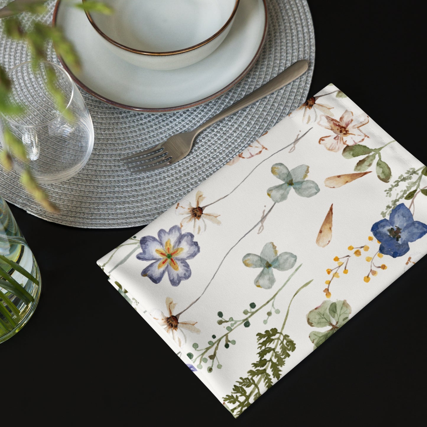 white wedding floral napkins next to grey placemat