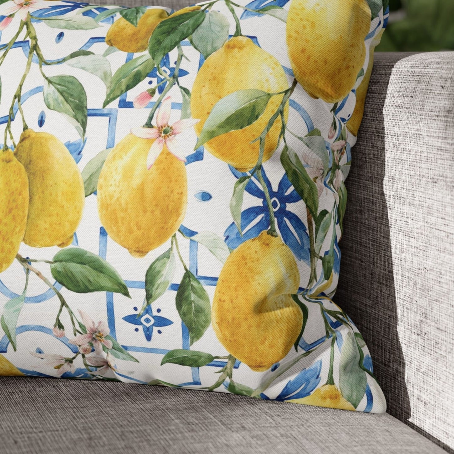 Yellow lemon pillow cover on gray couch – vibrant summer decor with watercolor design.