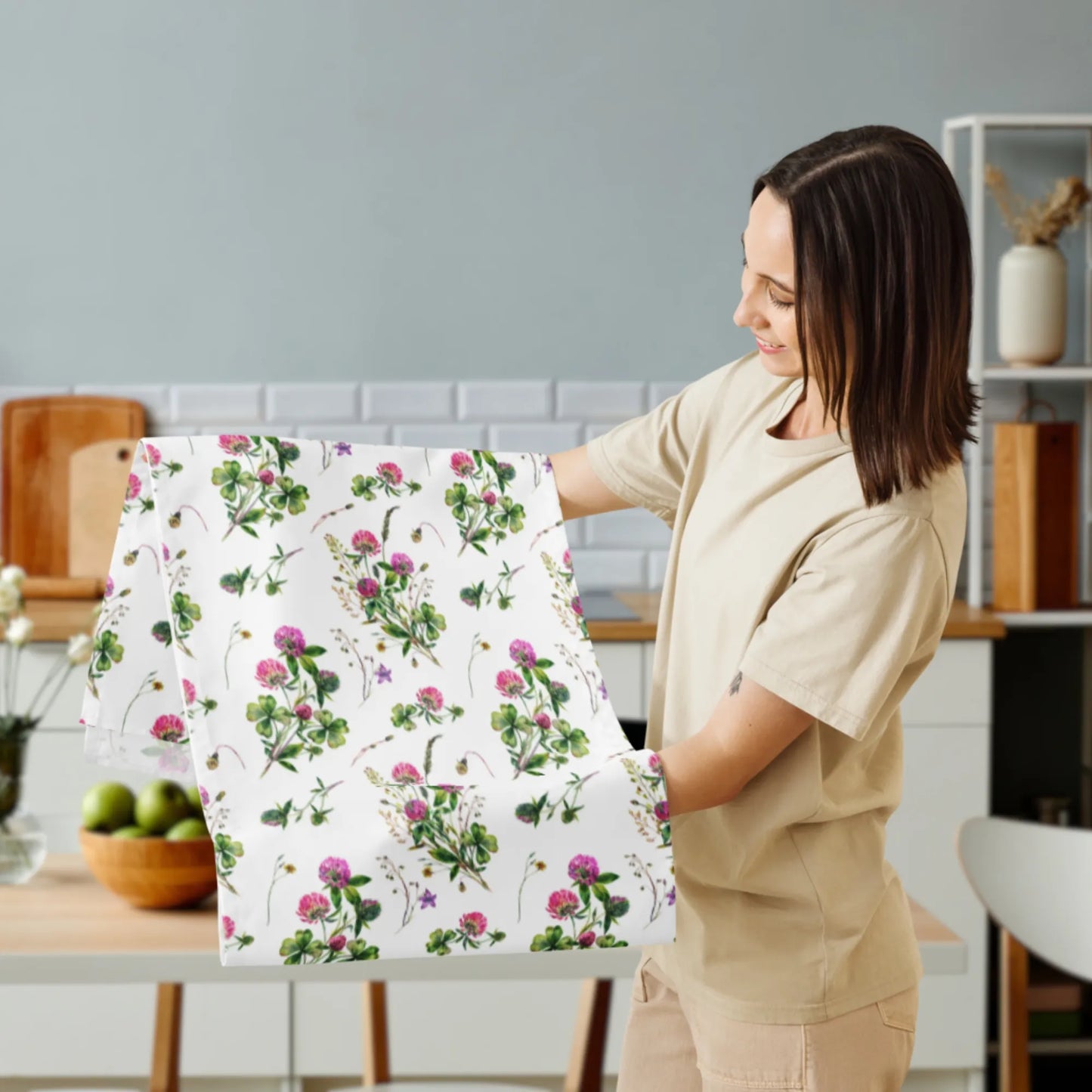 Woman holding botanical table runner with pink clovers and greenery – spring kitchen decor inspiration