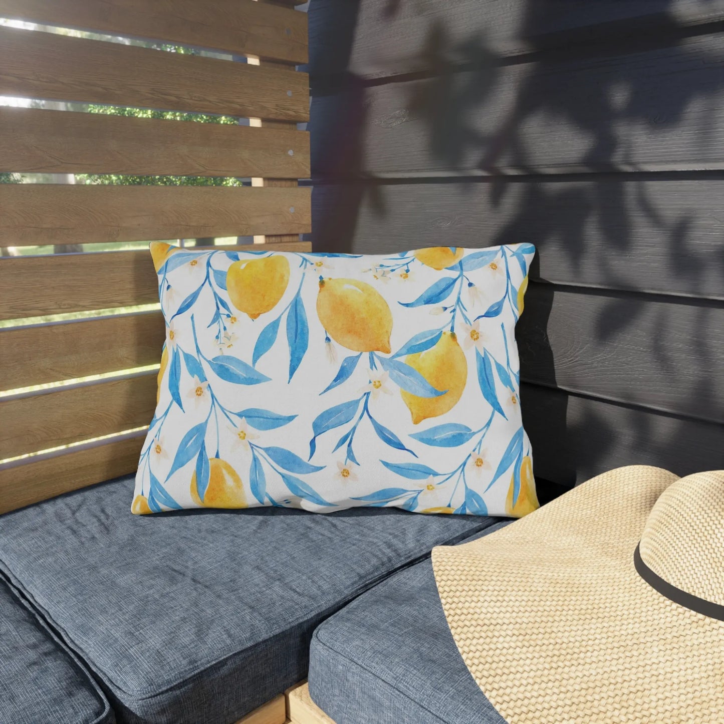 outdoor bench with Watercolor Lemon OUTDOOR PILLOW from Blue Water Songs on it