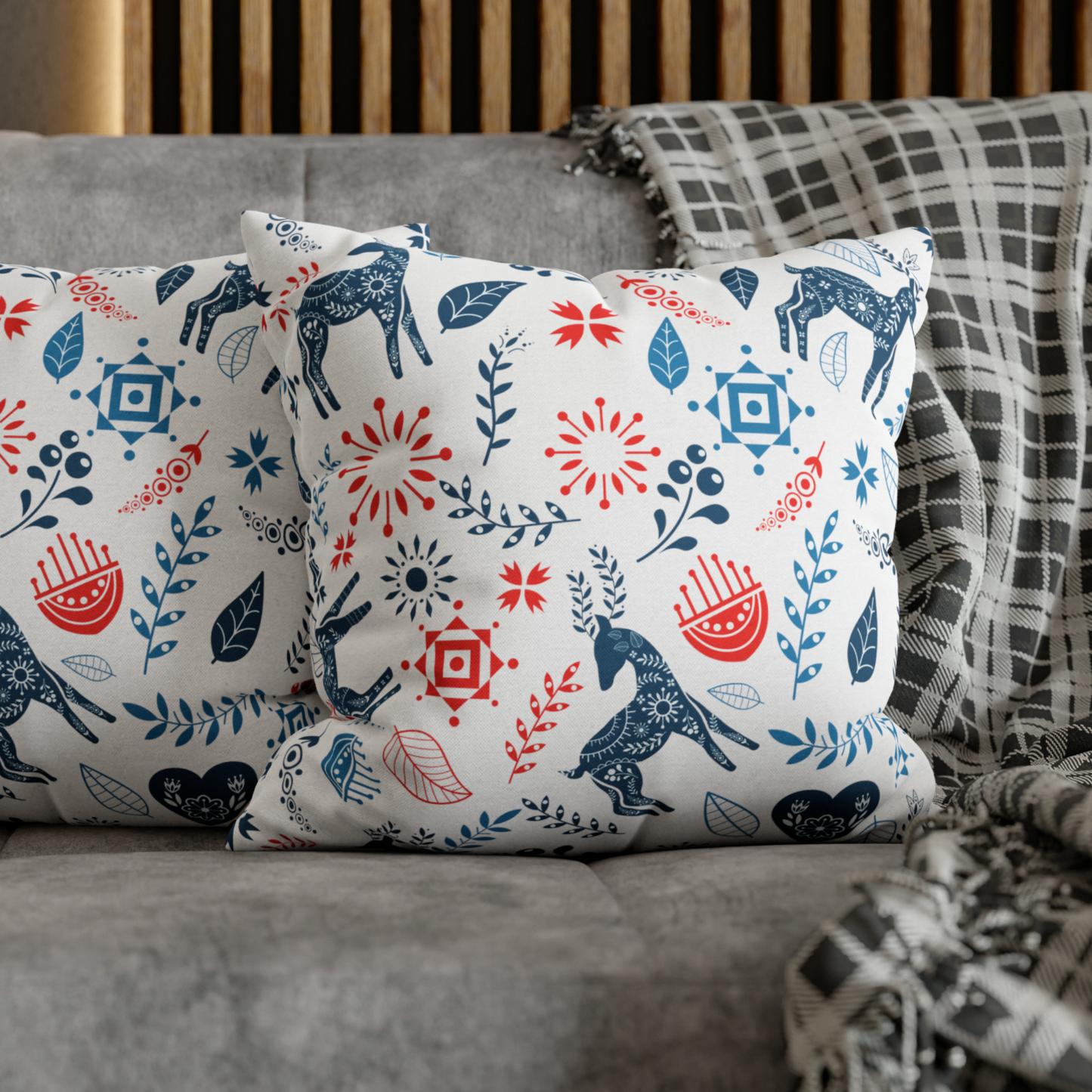 Reindeer Christmas Pillow cover with Nordic folk art patterns in blue and red on a cozy couch.