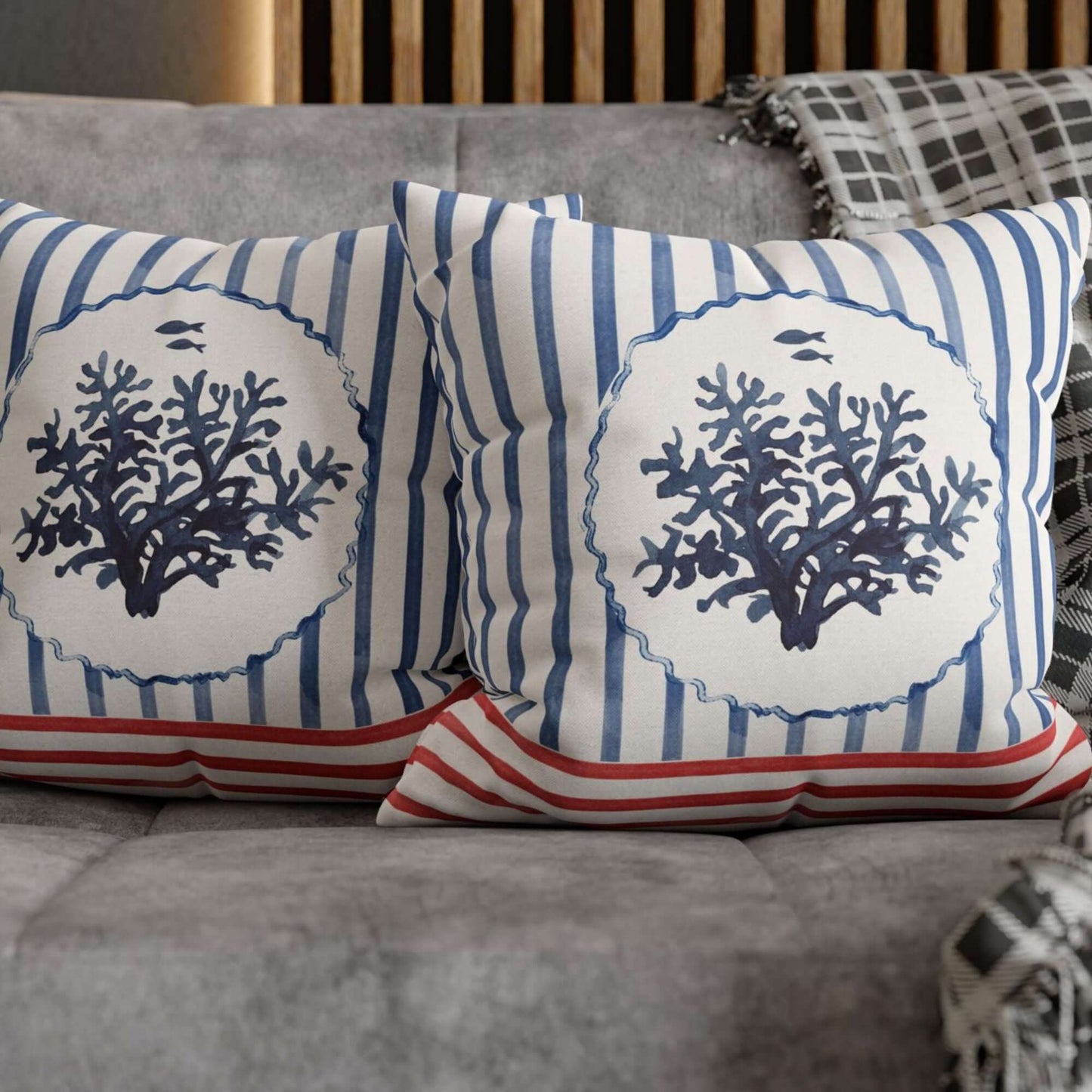 Watercolor Coral and Coastal Stripes Pillow and Cover featuring blue coral and striped design on cozy couch.