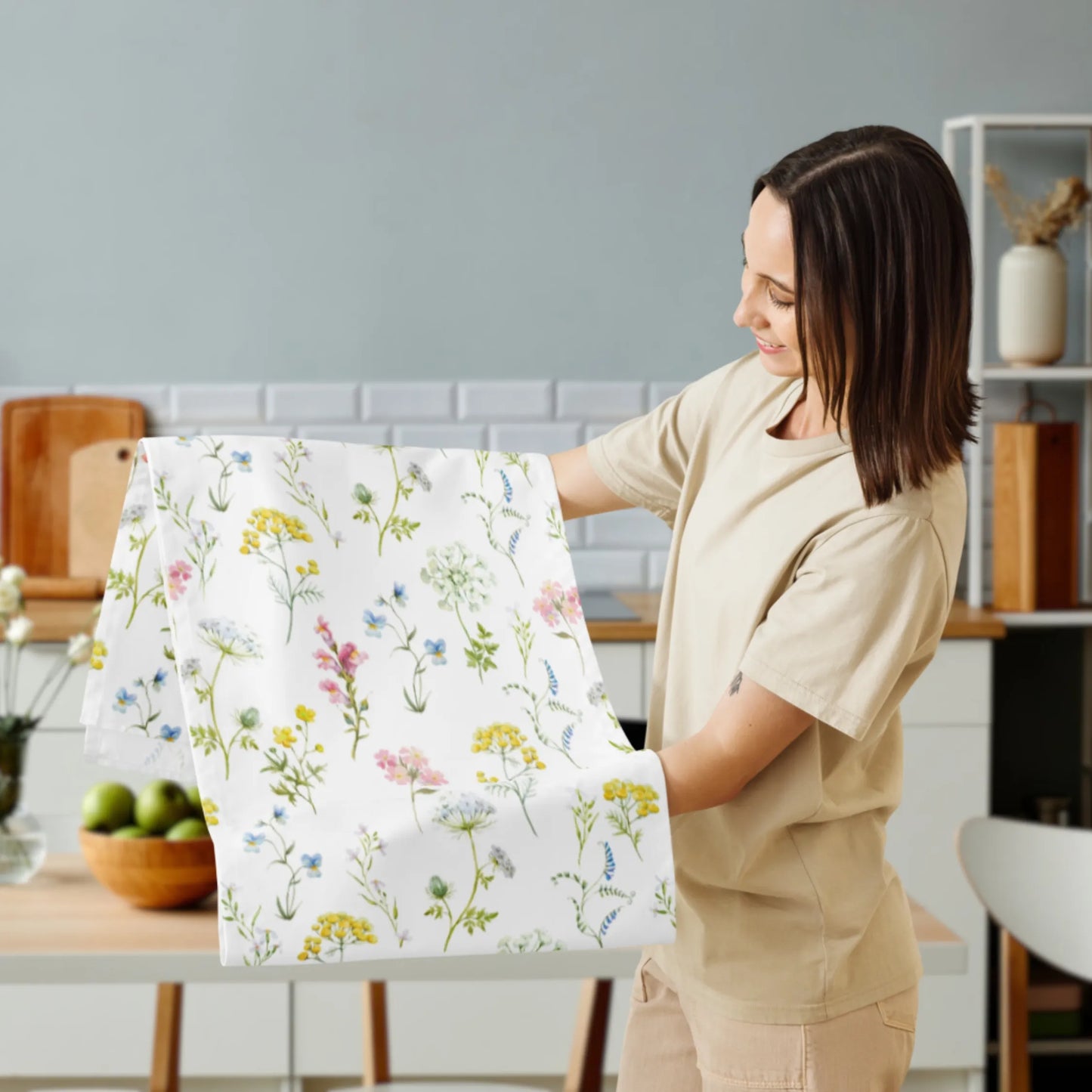 Woman holding watercolor table runner with yellow mimosa and wildflowers – fresh spring kitchen decor