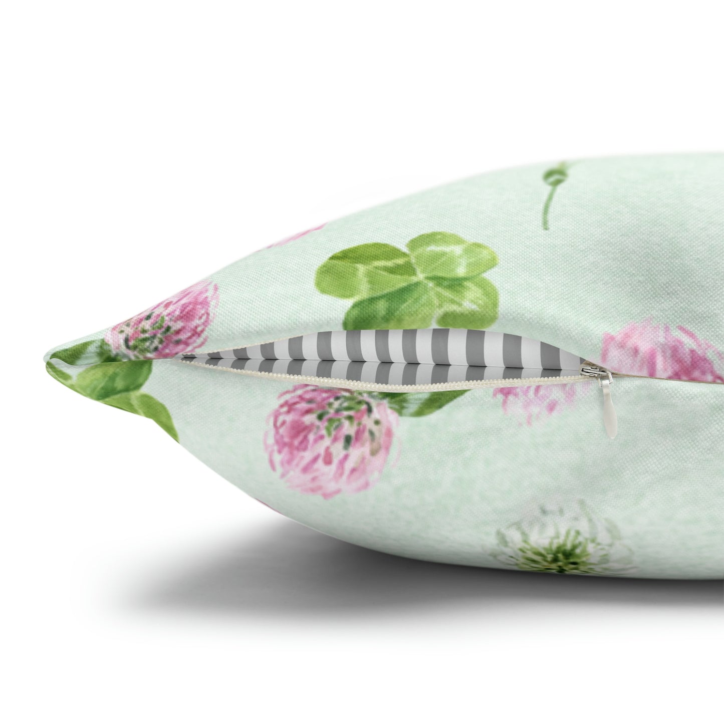 a decorative pillow with a feather and flowers on it