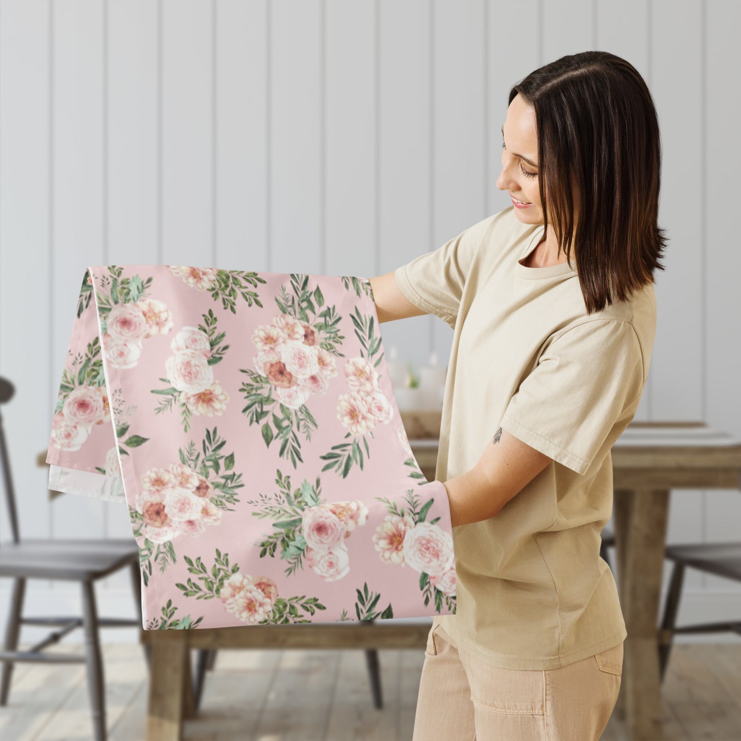 a woman holding a pink and white floral gift bag