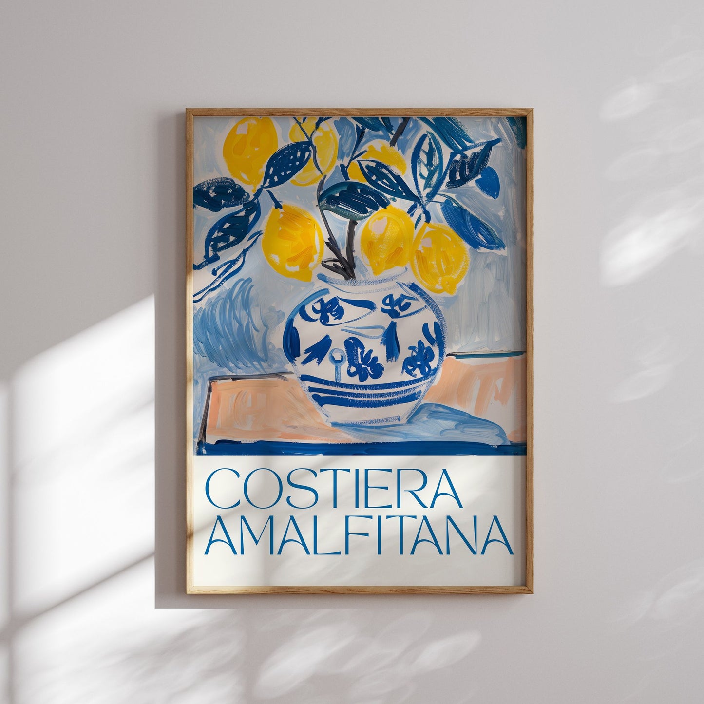 Framed lemon art print with blue and yellow vase illustration and “Costiera Amalfitana” text — Mediterranean summer decor, digital download poster.