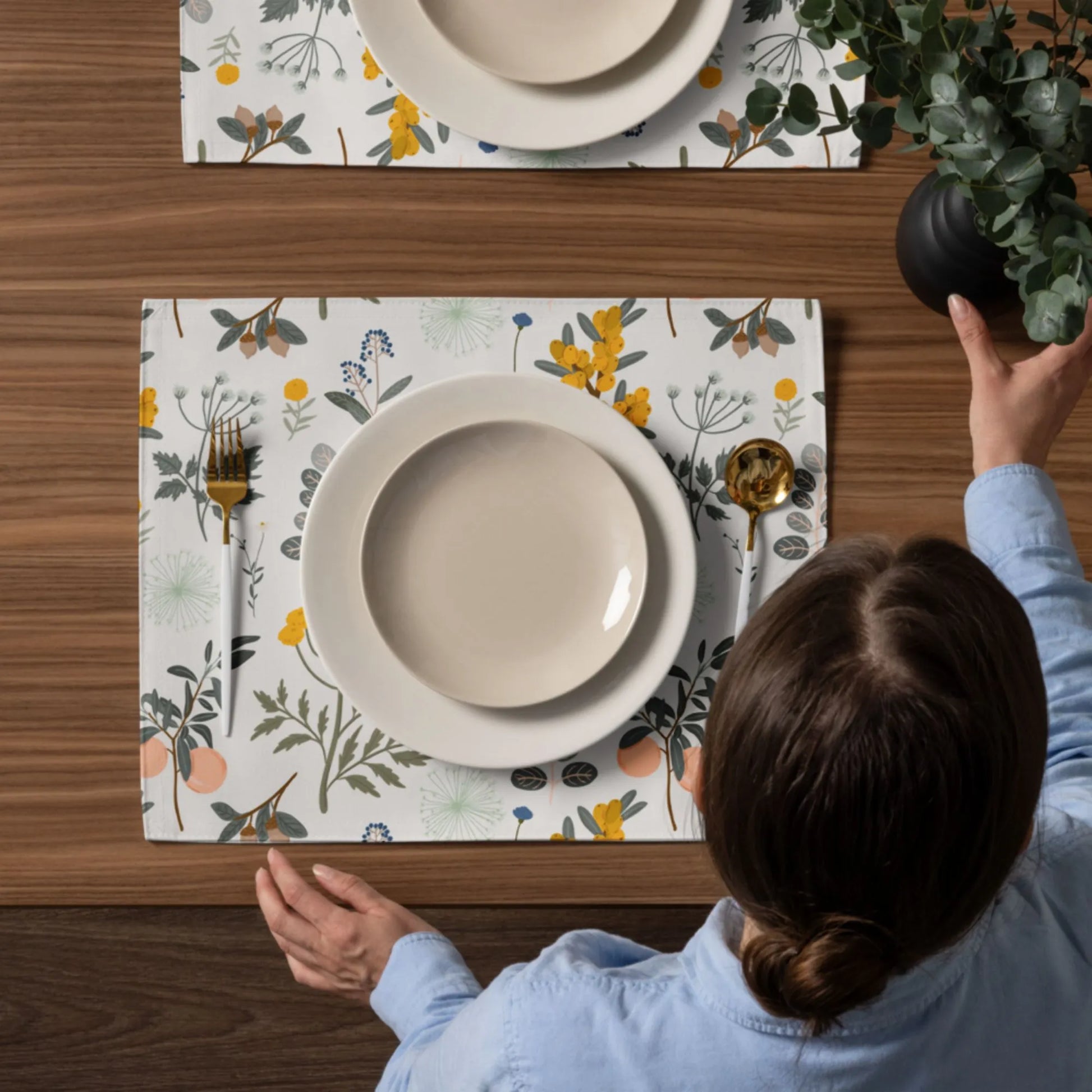 woman setting up dining table with Autumn Botanical PLACEMATS from Blue Water Songs