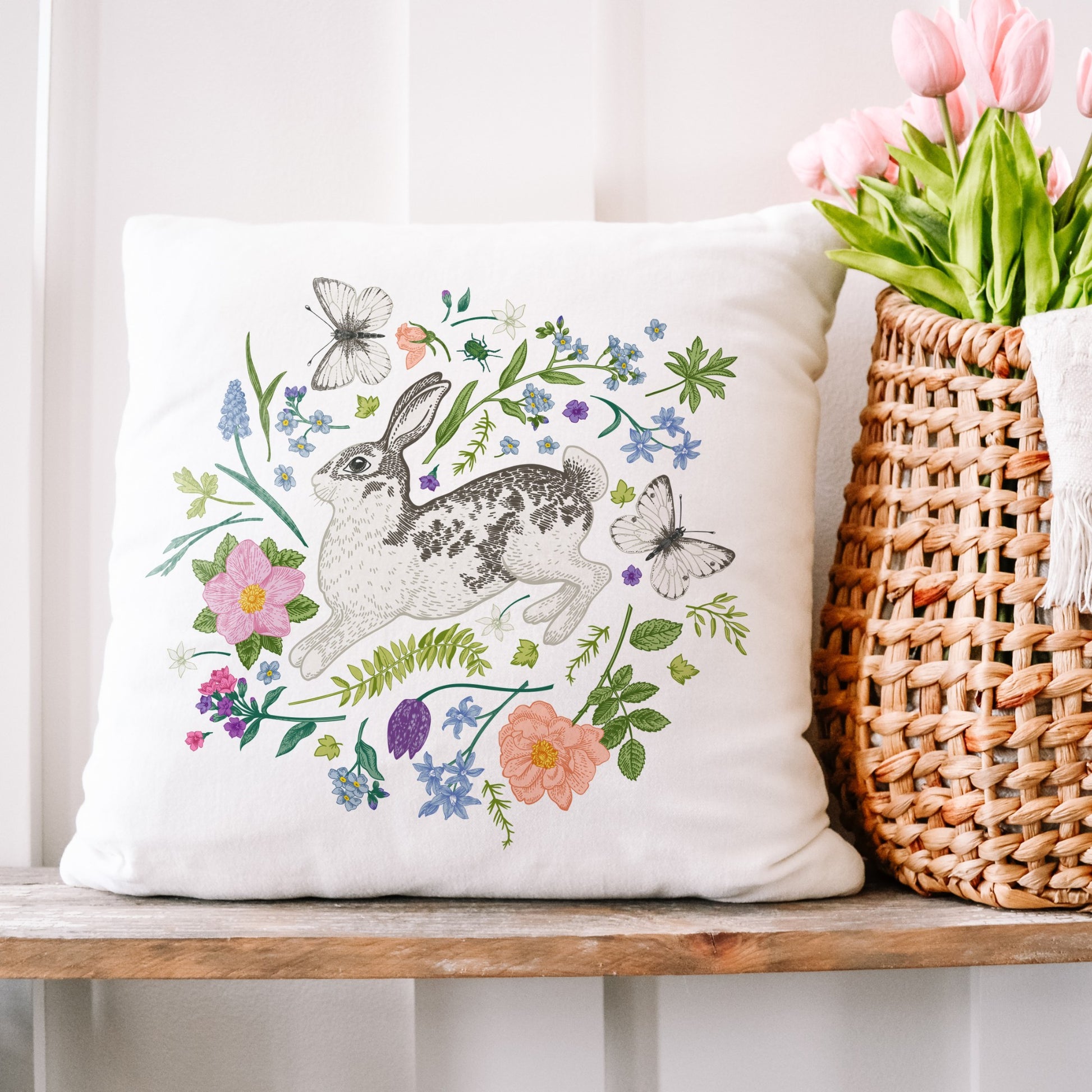 Bunny and Spring meadow PILLOW from Blue Water Songs on wood shelf next to vase of tulip flowers