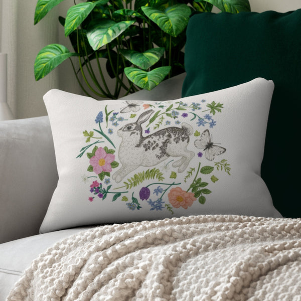 Bunny and Spring meadow lumbar PILLOW from Blue Water Songs on grey couch 