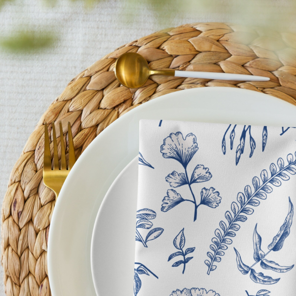 Blue Leaves Floral Cloth NAPKIN on white plate and papyrus placemat