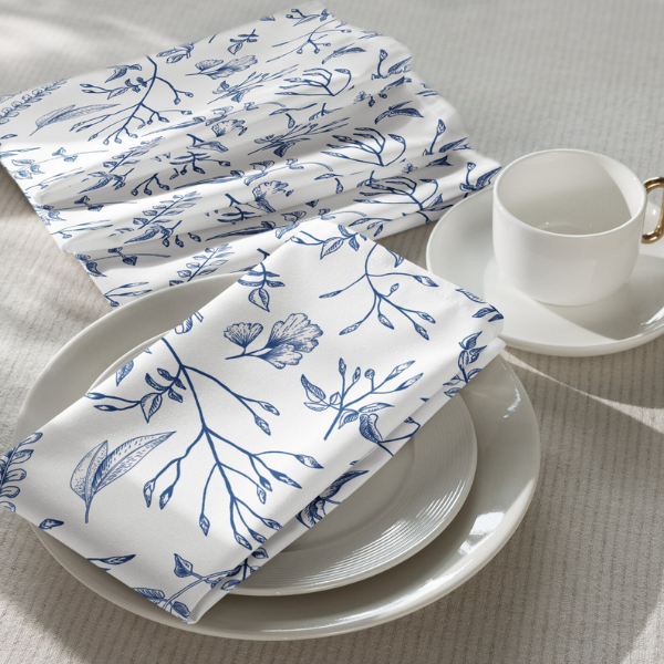 table with white plates and white blue napkins