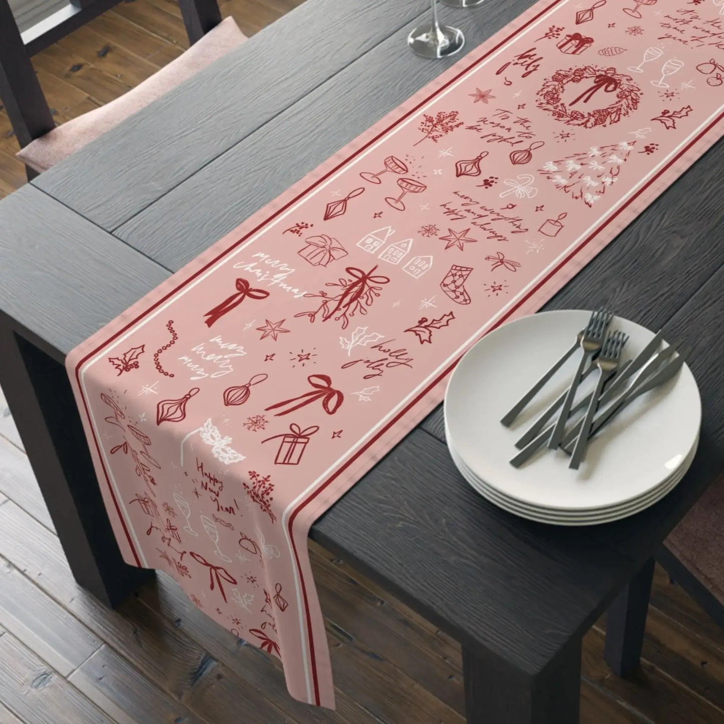 Blush Pink Christmas Table Runner with red line art on a dining table, perfect for holiday decor.