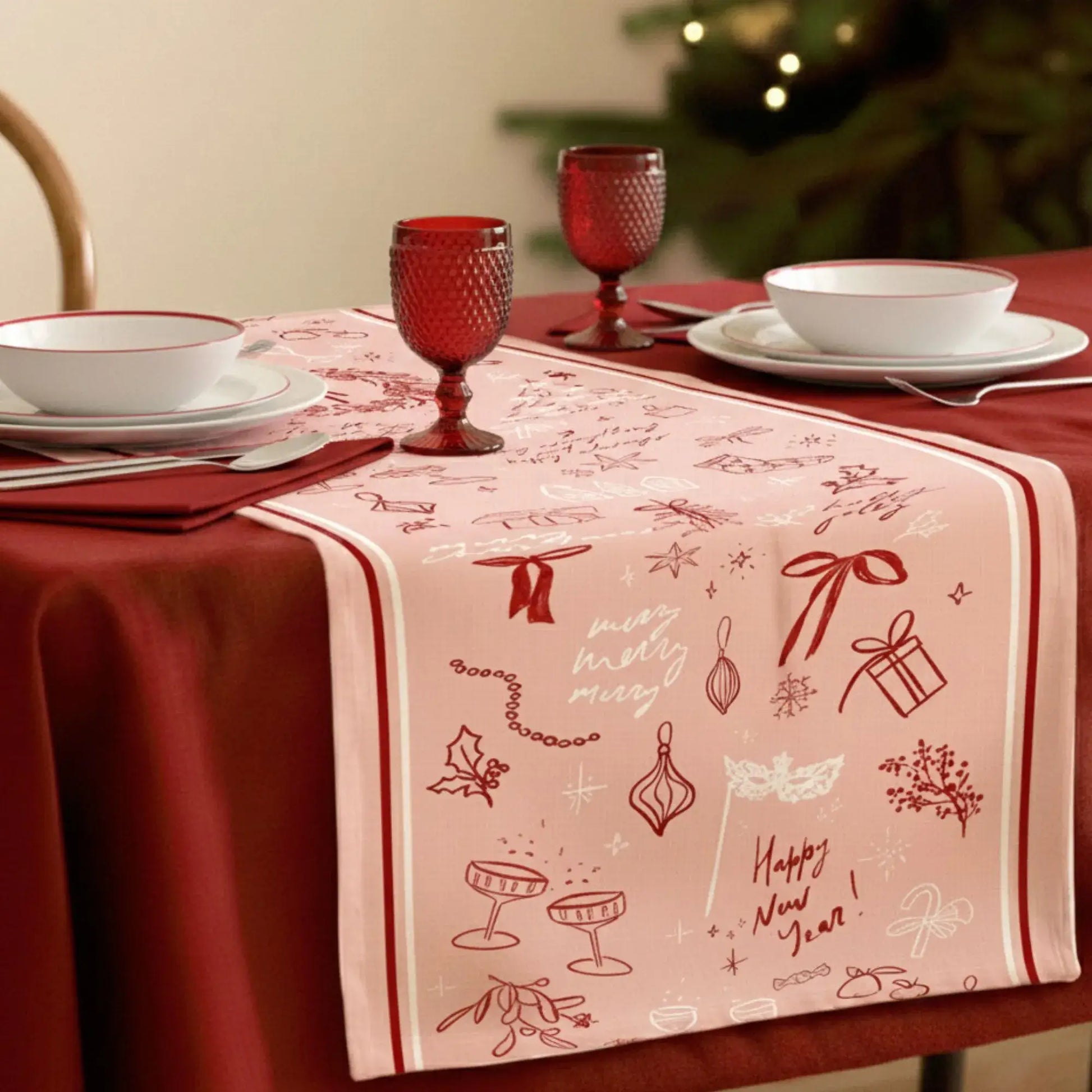 Blush Pink Christmas Table Runner with red line art, perfect for festive holiday decor and cozy dinners.