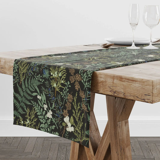 Botanical Christmas table runner showcased on a wooden table with elegant winter foliage and berries.