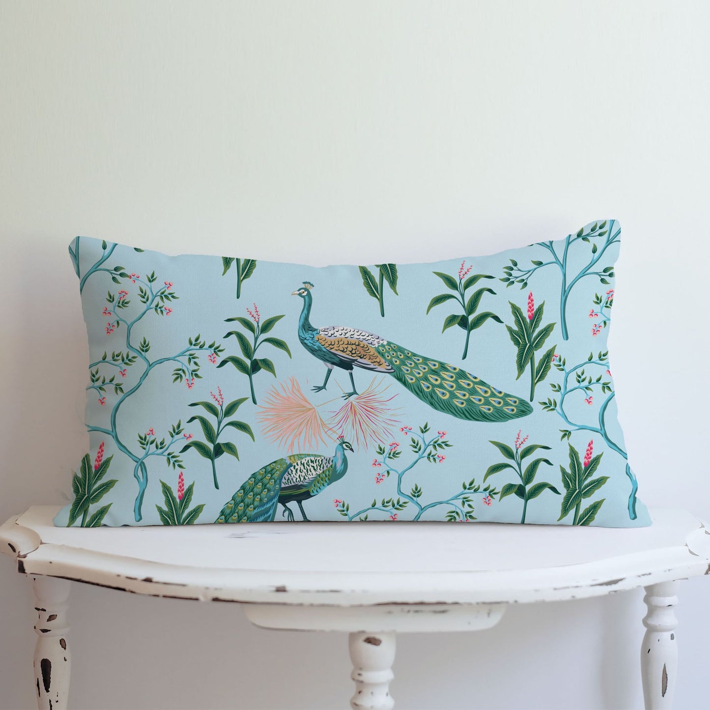 blue peacock pillow on white table