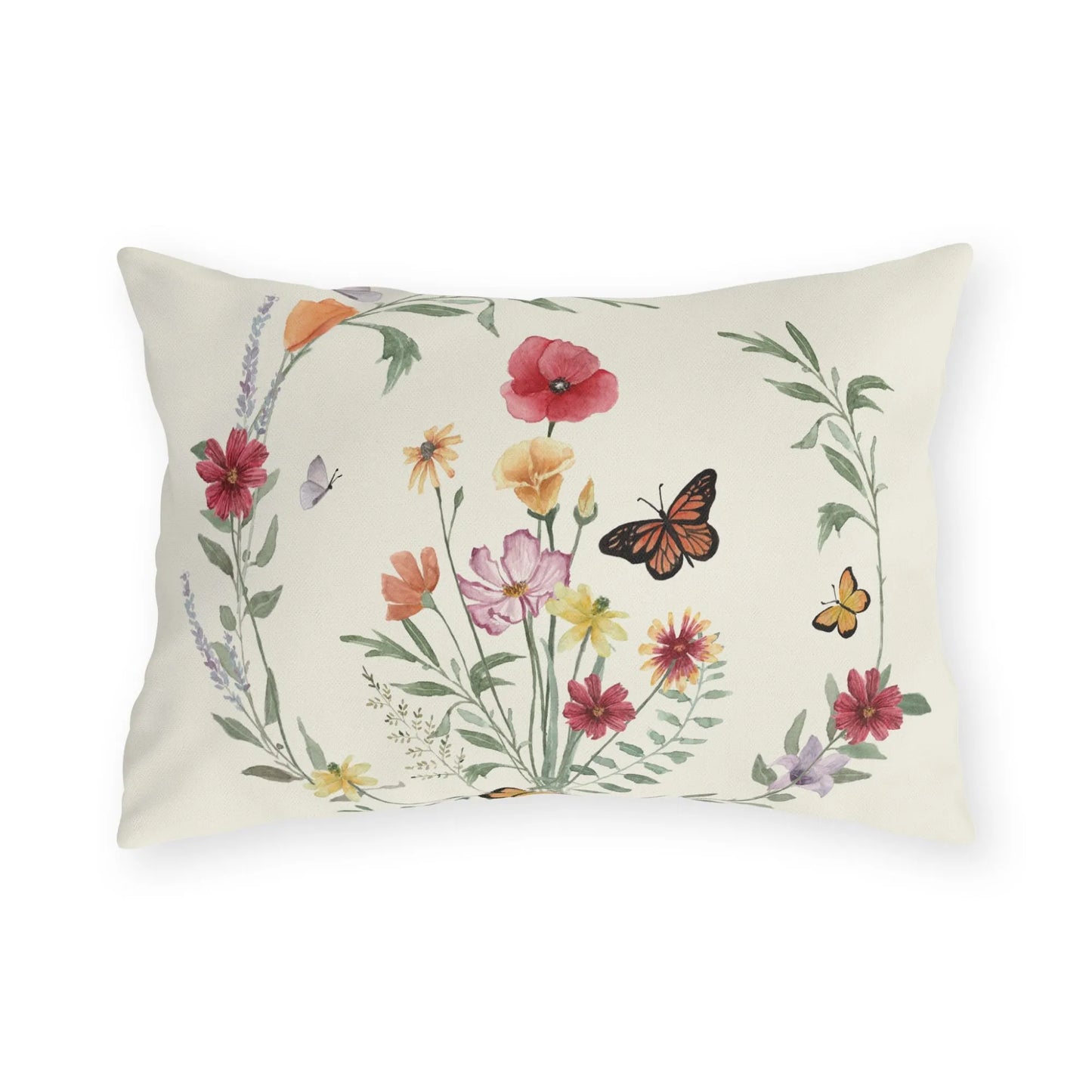 Nature-inspired outdoor pillow with watercolor wildflowers and butterflies in a circular wreath on a warm cream background.
