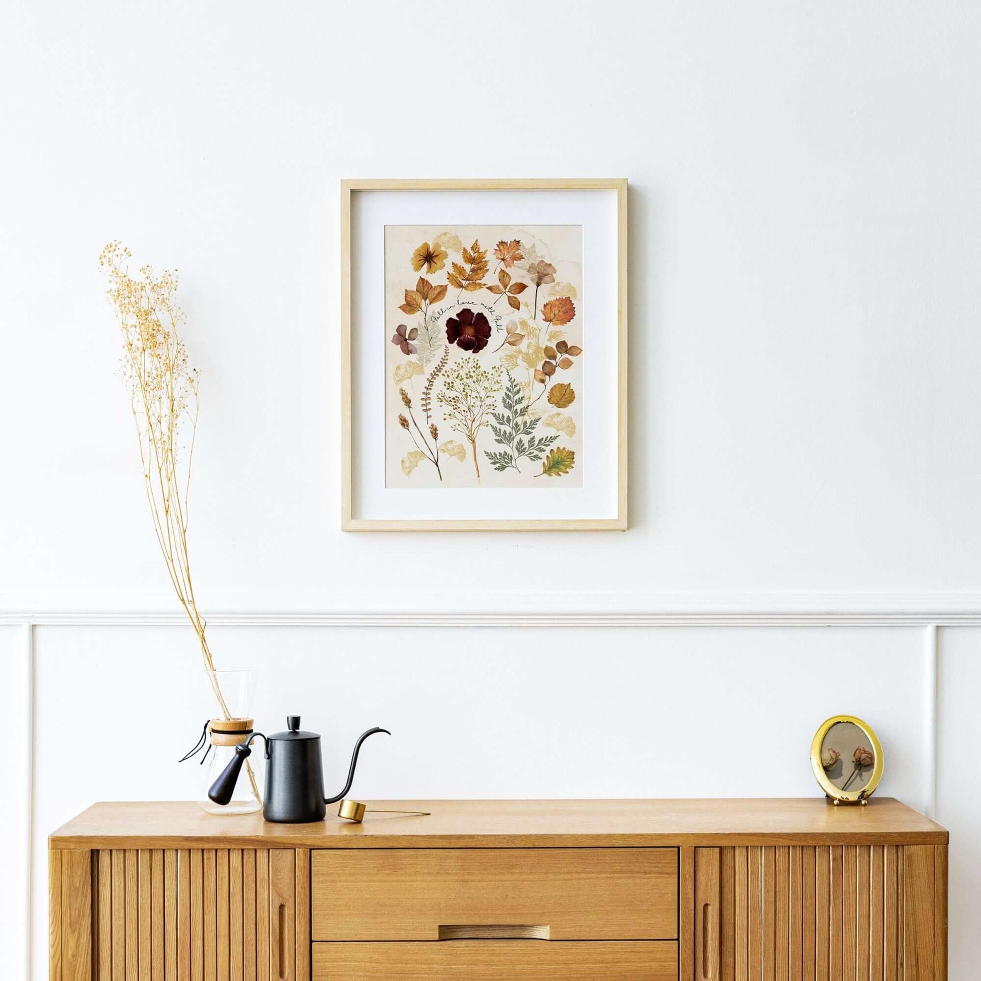 living room with Fall Leaves Autumn Art Print from Blue Water Songs on wall and wood buffet cabinet 