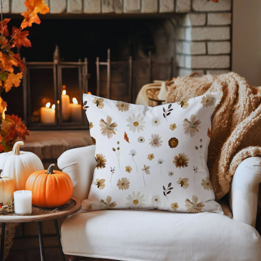 cozy white sofa with Watercolor Fall Wildflowers PILLOW from Blue Water Songs on it next to table with pumpkins