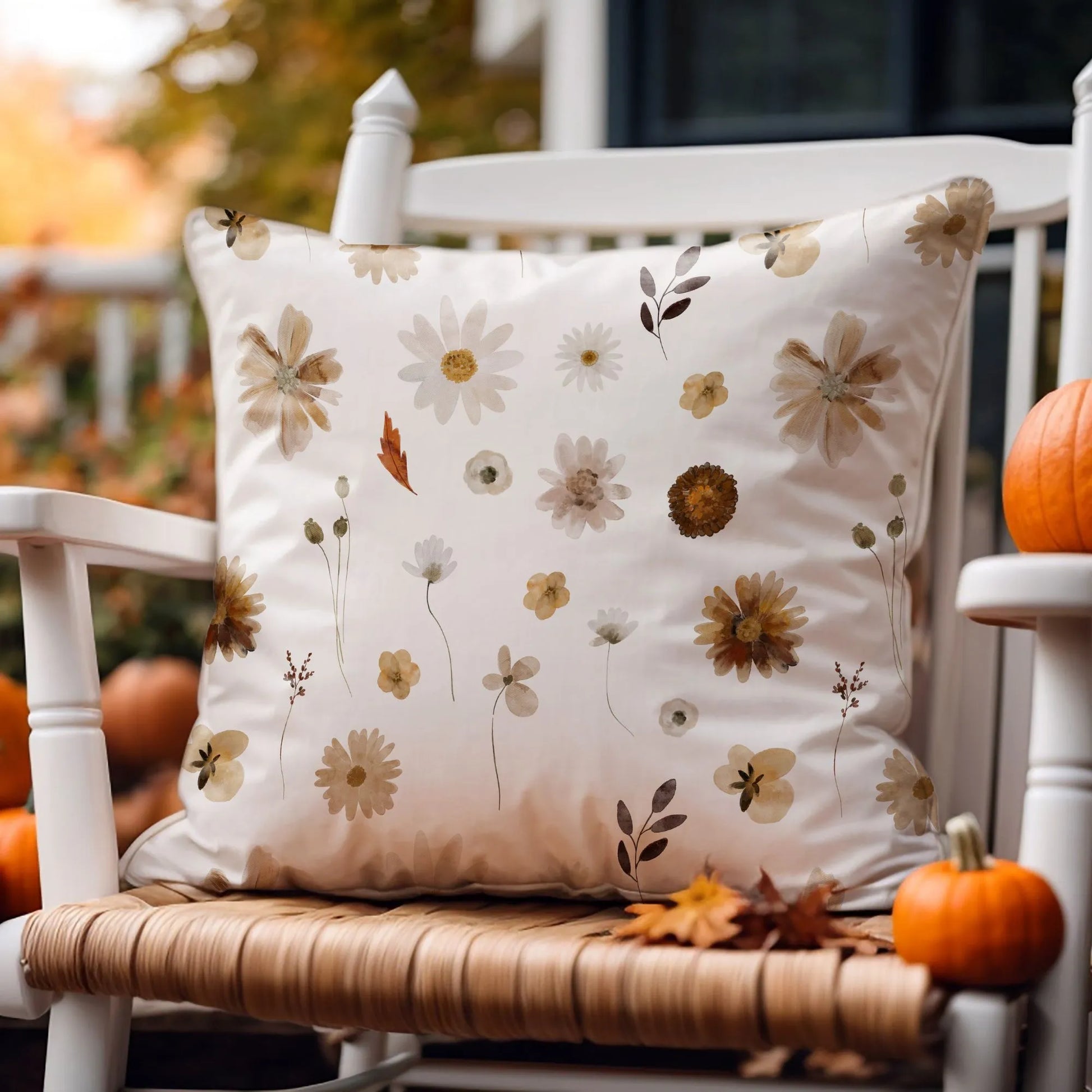 outdoor chair with Watercolor Fall Wildflowers PILLOW from Blue Water Songs and pumpkins on it
