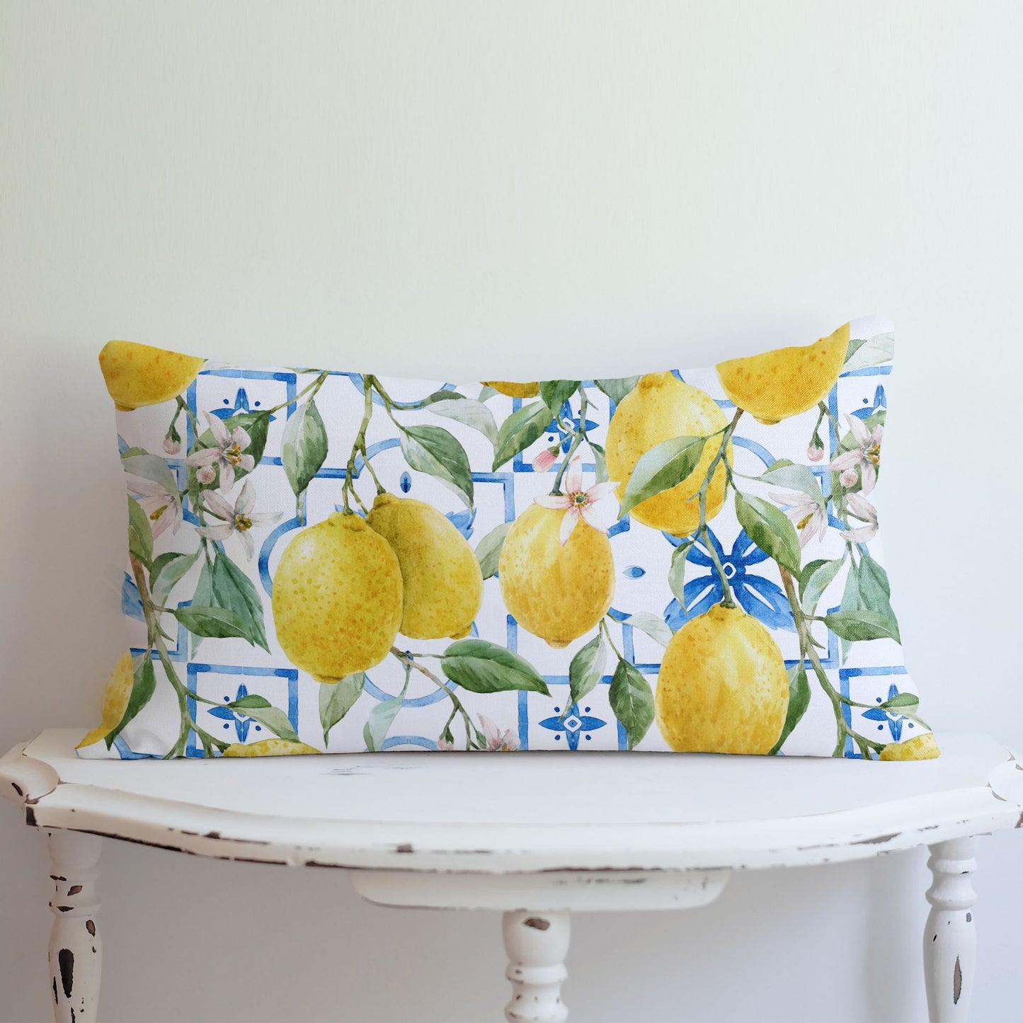 Colorful lemon lumbar pillow cover on white vintage table – vibrant summer decor.