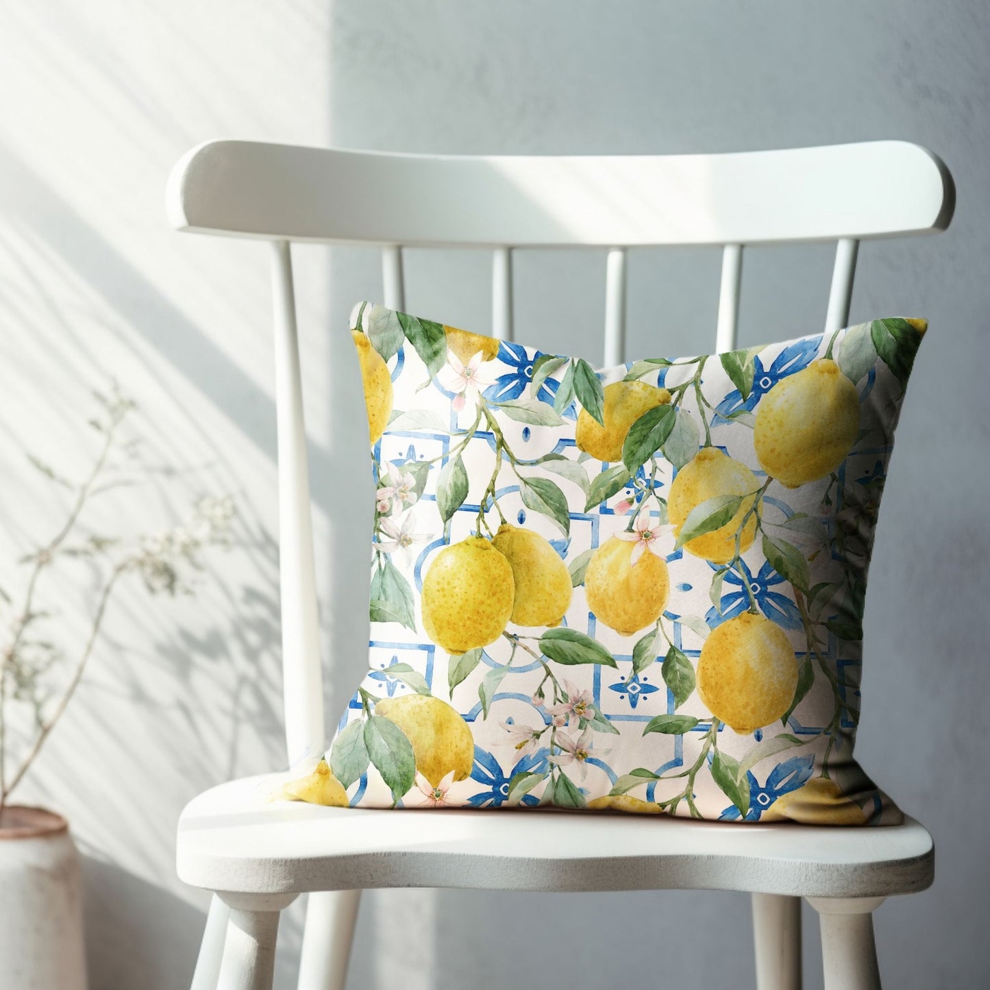 Colorful lemon pillow cover on white chair – bright summer watercolor home decor.