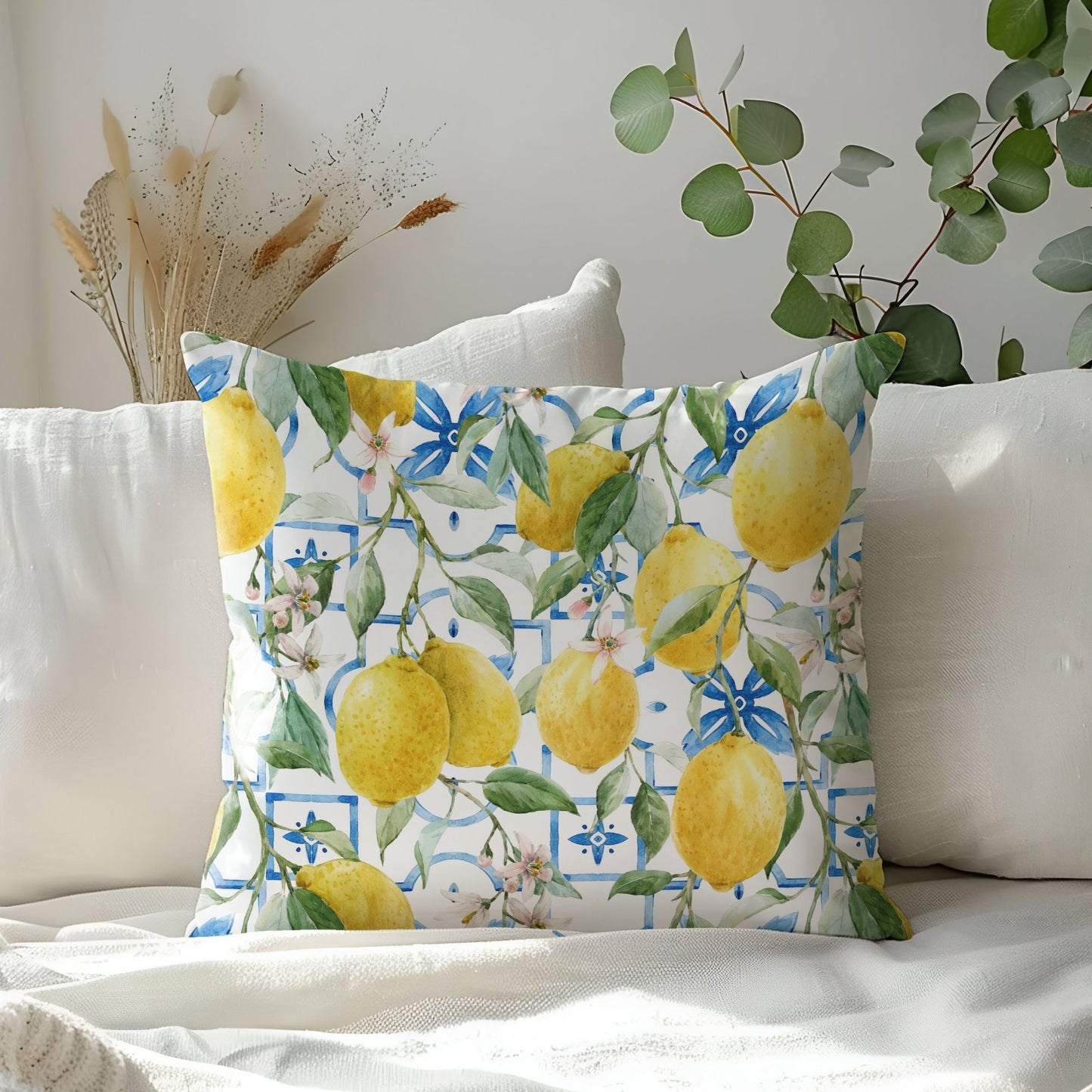 Colorful lemon pillow cover with bright lemons on white couch – fresh summer home decor.