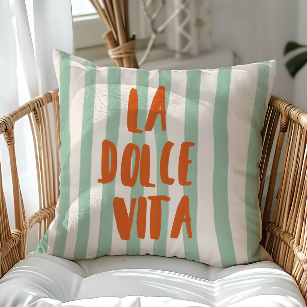 La Dolce Vita Green striped PILLOW from Blue Water Songs on rattan chair