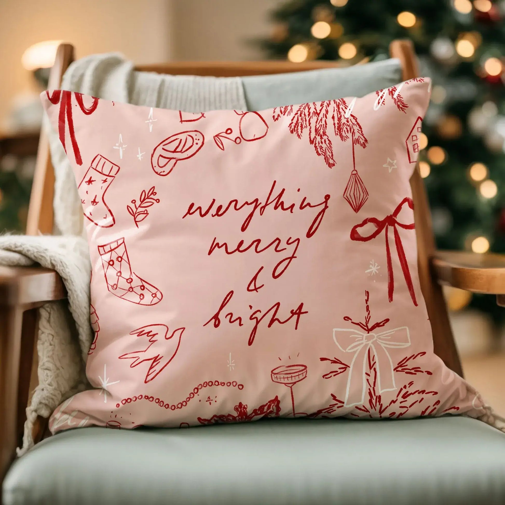 Merry and Bright Christmas Pillow Cover featuring whimsical sketches of holiday elements on a cozy chair.