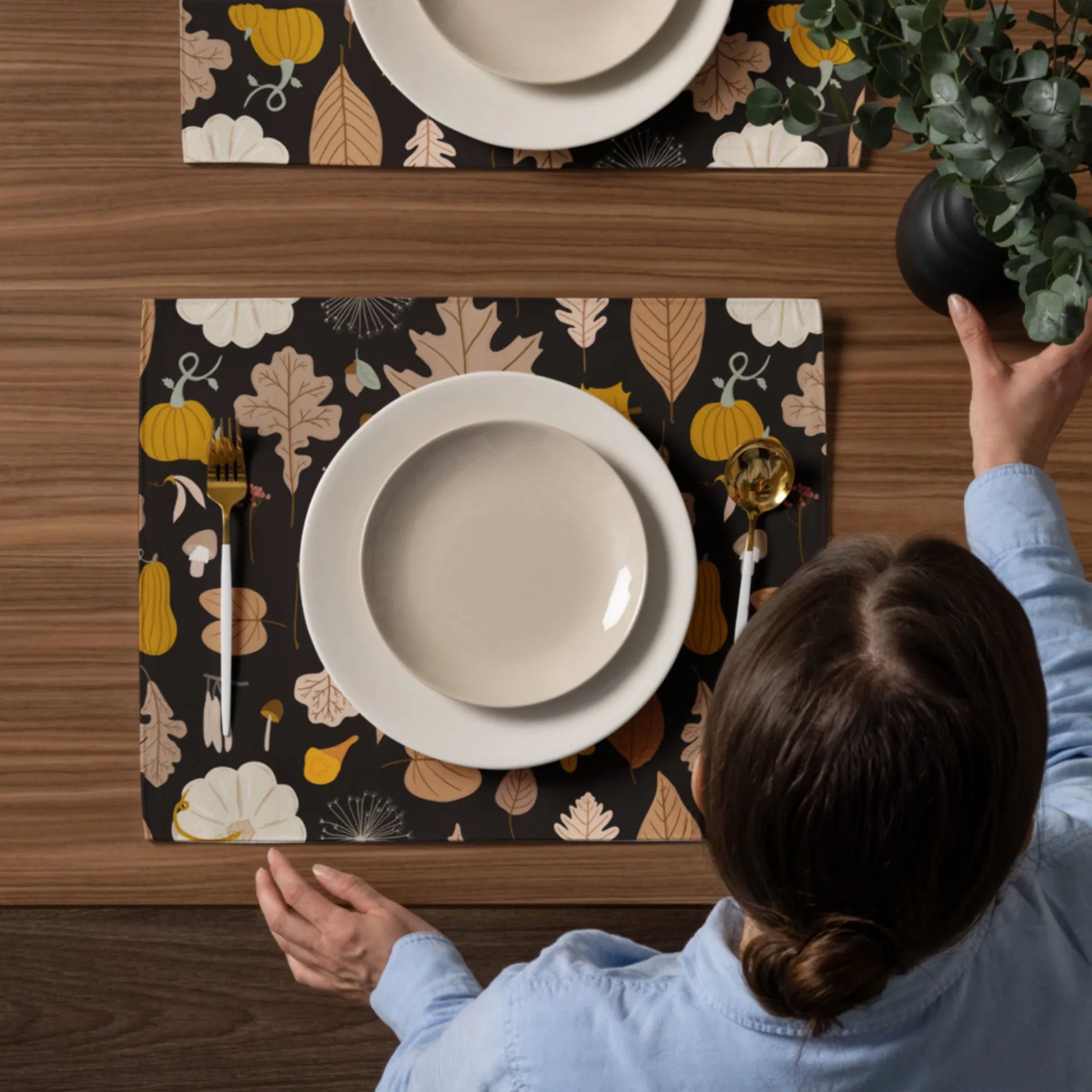 woman setting up dining table with Autumn Pumpkin PLACEMATS from Blue Water Songs 