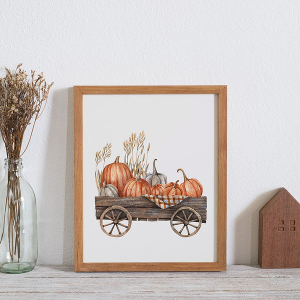 Autumn Pumpkin cart poster from Blue Water Songs next to dry flower bottle