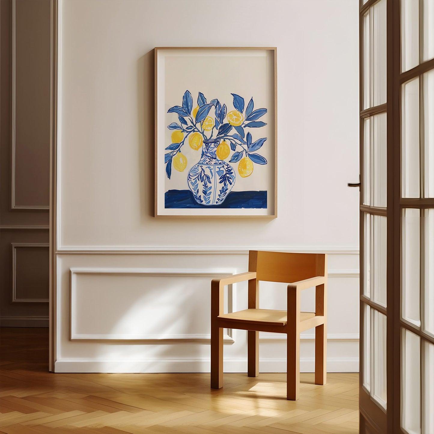 Lemon vase botanical art print in wood frame, styled above a modern wood chair in a sunlit cream hallway with wall paneling