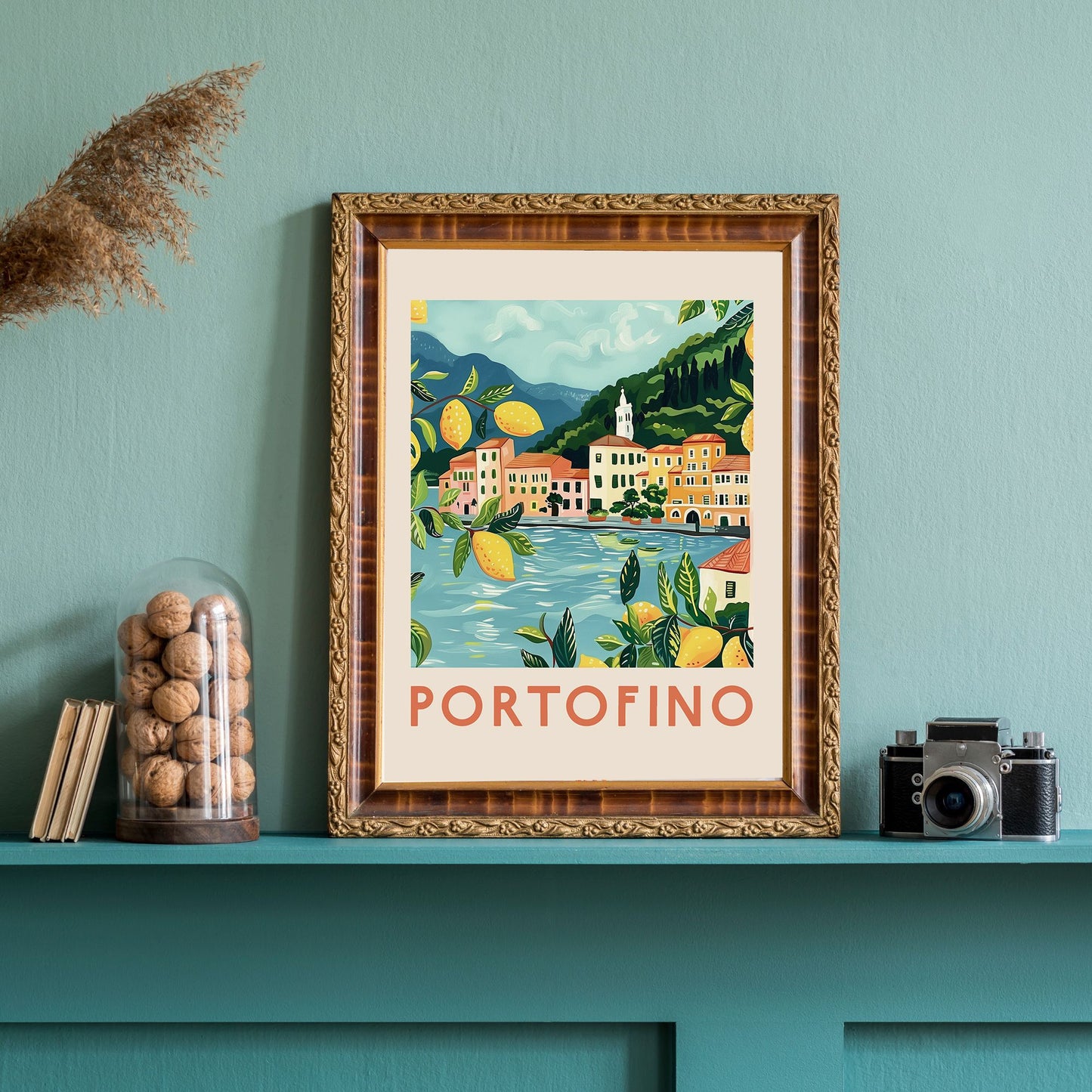Framed Portofino coastal art print with lemon branches, styled on a teal shelf with vintage camera and glass walnut jar