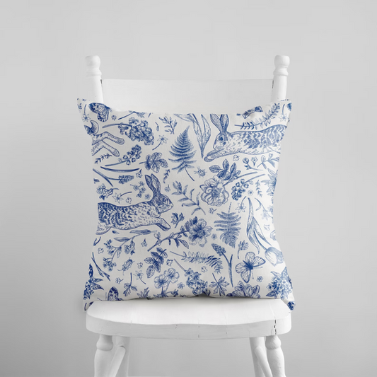 Bunny and spring floral BLUE PILLOW from Blue Water Songs on white chair