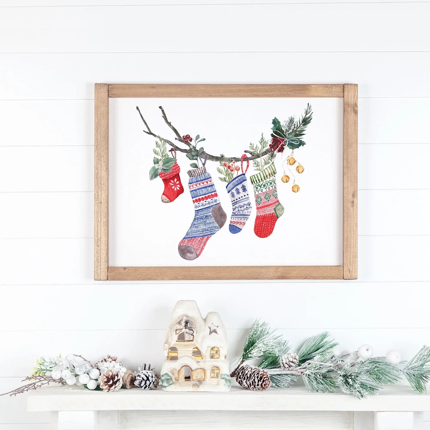 Watercolor Christmas Stocking Art Print featuring colorful holiday stockings hanging on a branch.