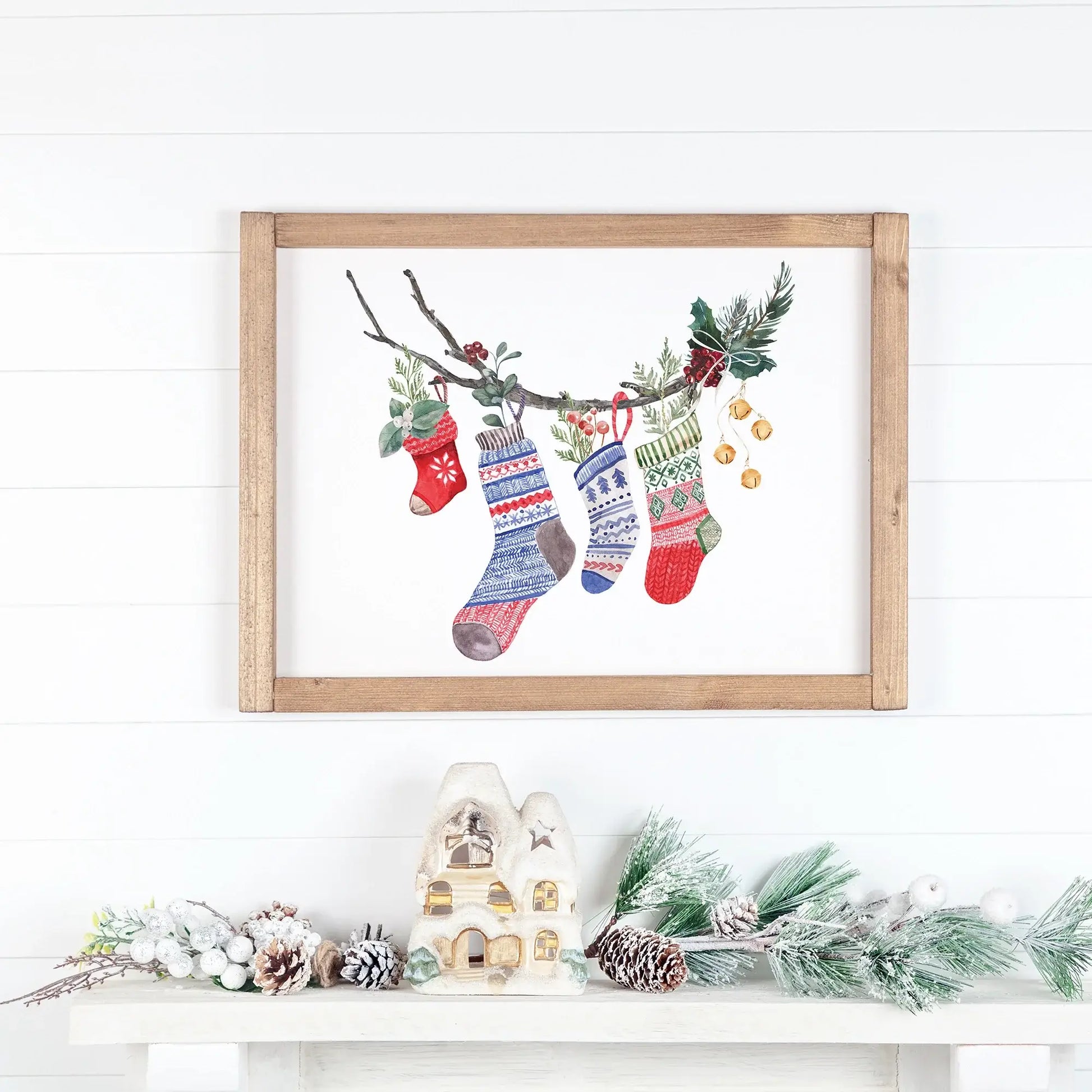 Watercolor Christmas Stocking Art Print featuring colorful holiday stockings hanging on a branch.