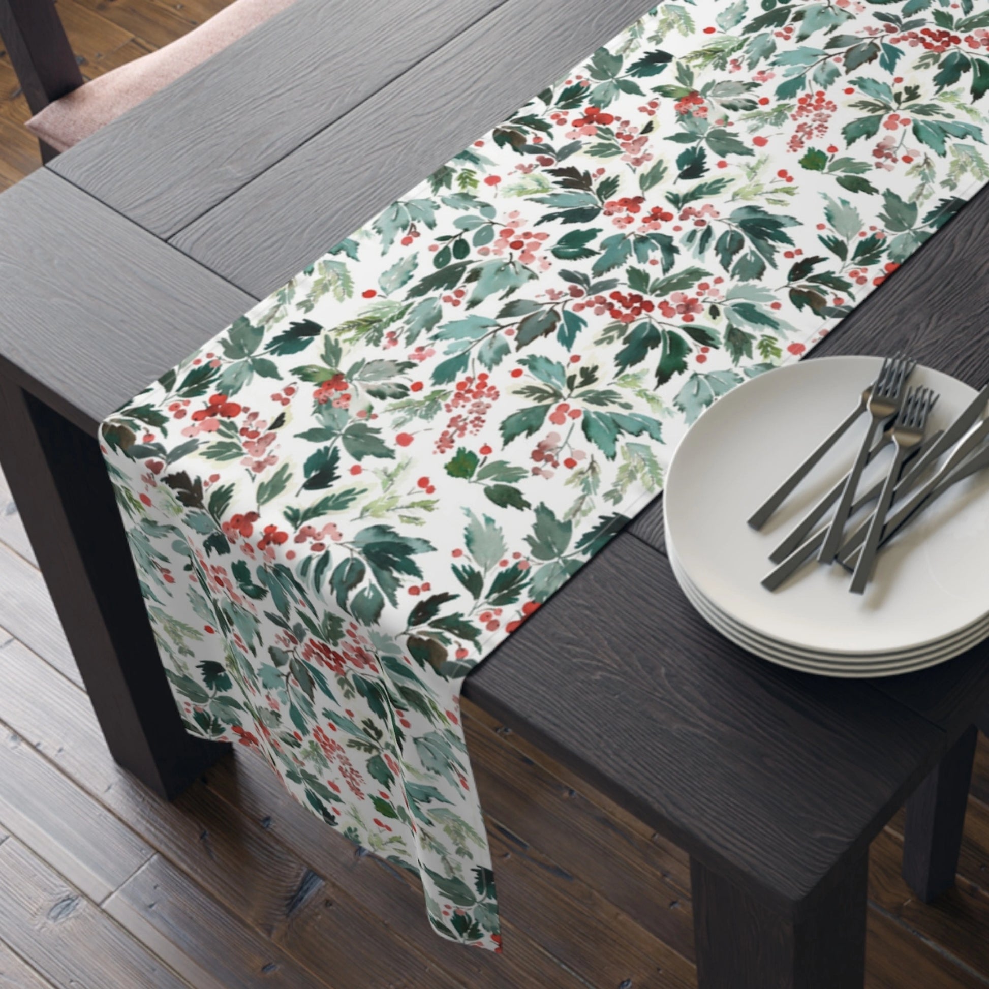 Watercolor Christmas Table Runner featuring red holly and green leaves on a wooden table with plates and utensils
