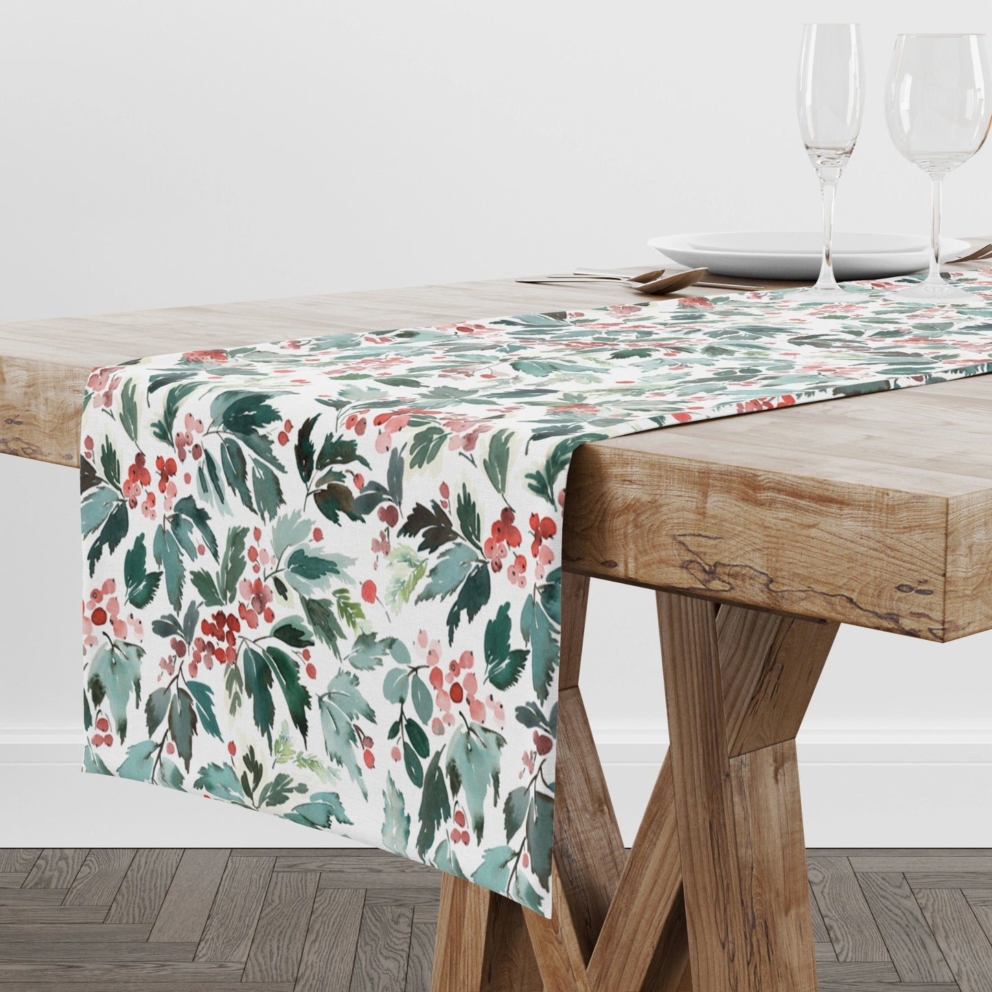 Watercolor Christmas Table Runner featuring red holly and green leaves on a wooden dining table.