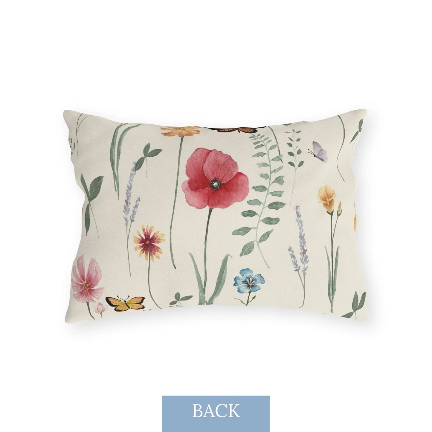 Back view of a rectangular outdoor pillow featuring watercolor wildflowers, butterflies, and greenery on a light cream background.