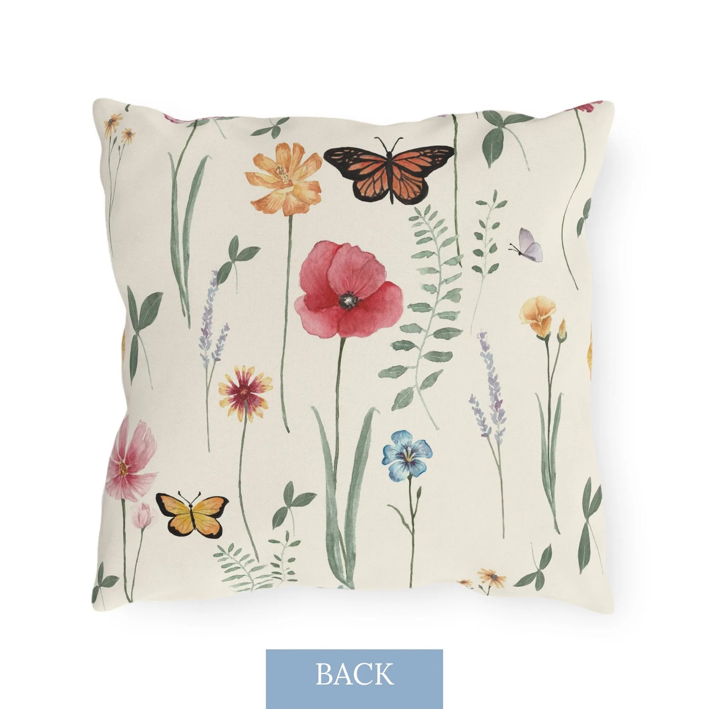 Back view of a square outdoor pillow with a watercolor wildflower and butterfly design on a light cream background.