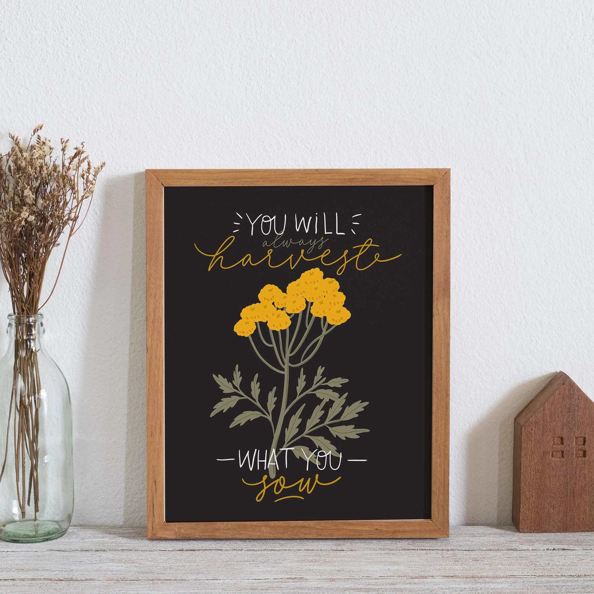 poster "you will always harvest what you sow" placing on wall shelf