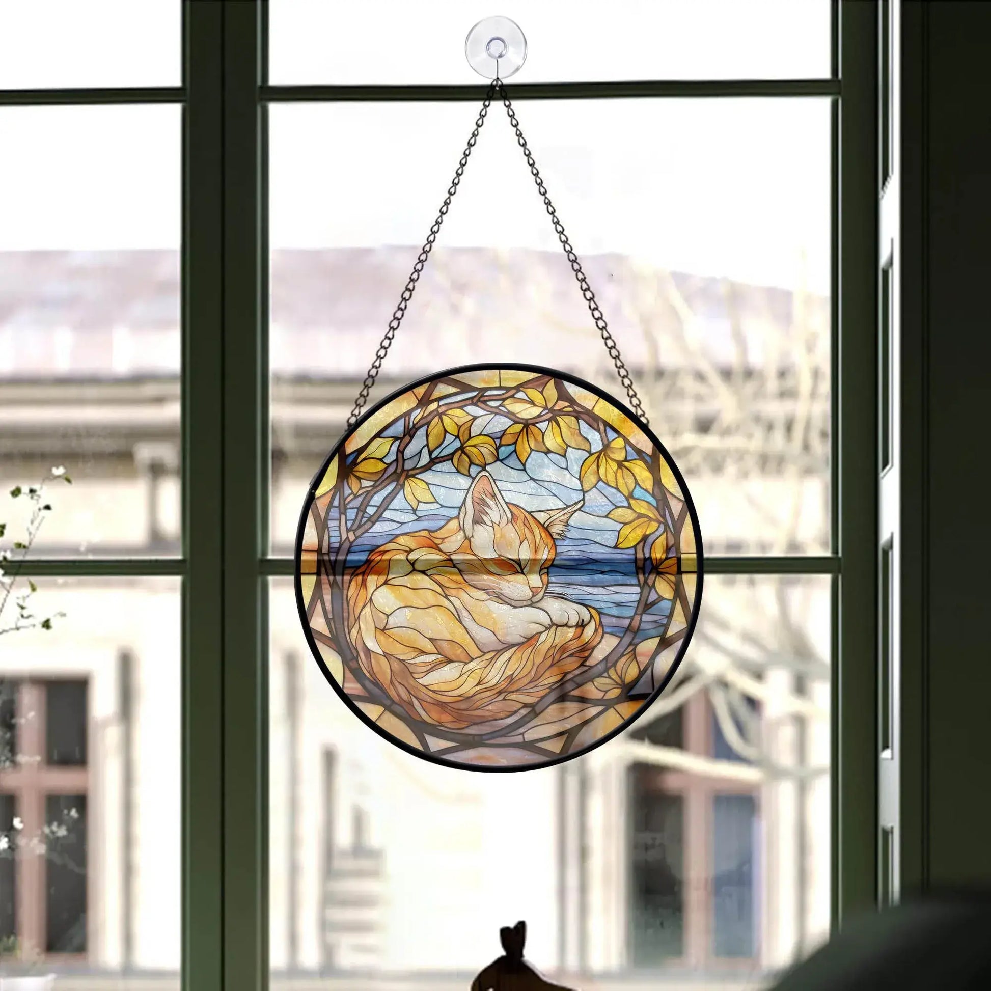 green framed window with cute Sleeping Cat Round-Stained Glass Ornament by Blue Water Songs hanging on it