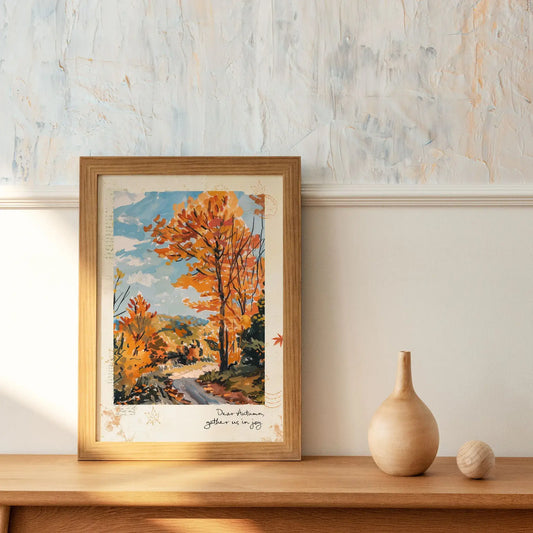 Framed autumnal wall art print with golden trees and path, captioned “dear autumn, gather us in joy,” seasonal home decor