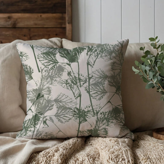 brown sofa with Birch Leaves Herbarium green PILLOW from Blue Water Songs on it