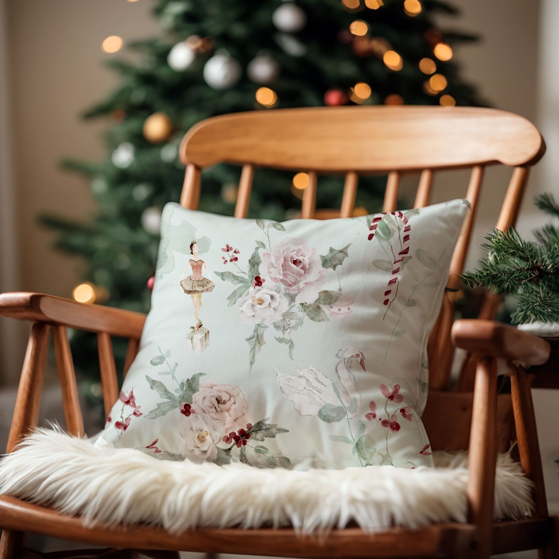 Ballerina Christmas Pillow Cover featuring floral design on a cozy chair by a decorated Christmas tree.