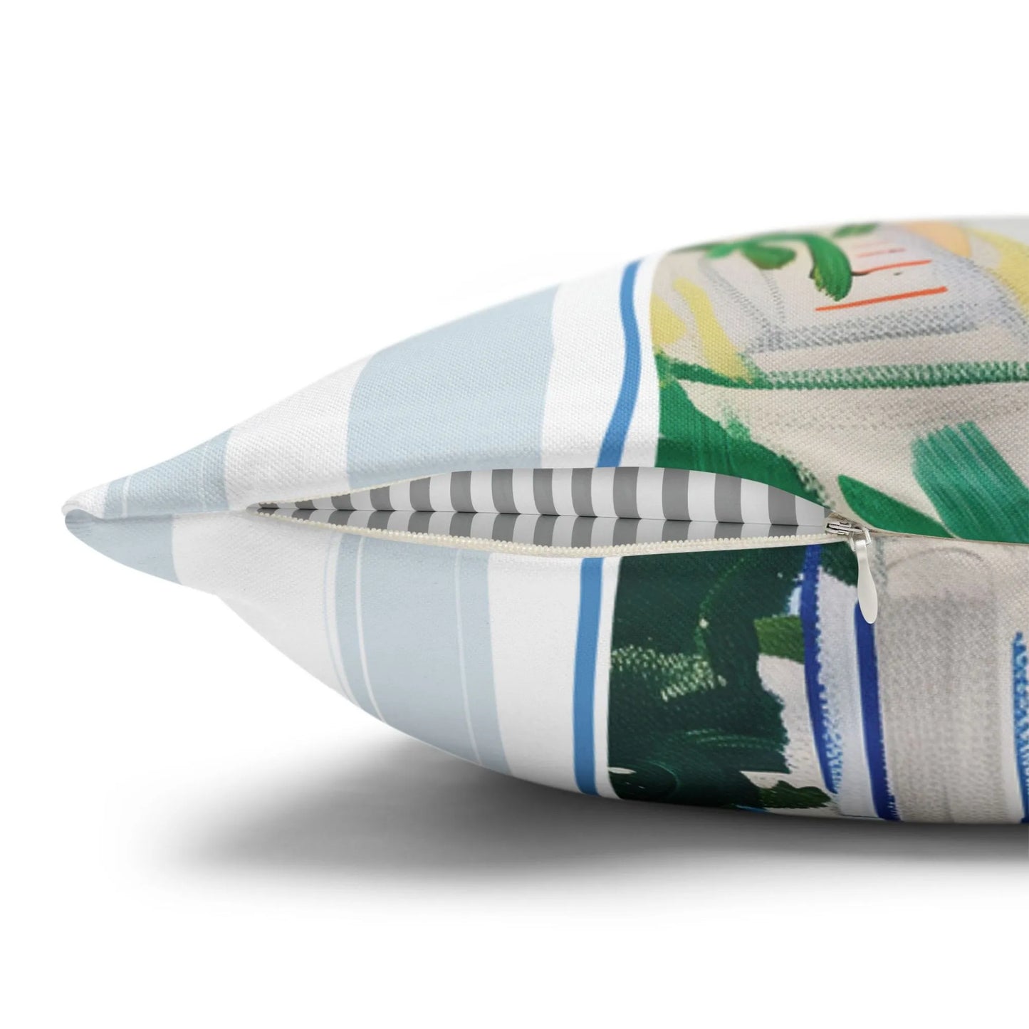 Close-up of Mediterranean pillow cover zipper with striped inner lining and ocean-inspired print