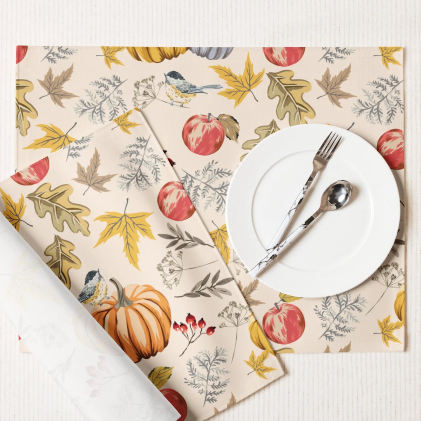 Pumpkin and bird PLACEMATS from Blue Water Songs with white plate, fork and spoon on it