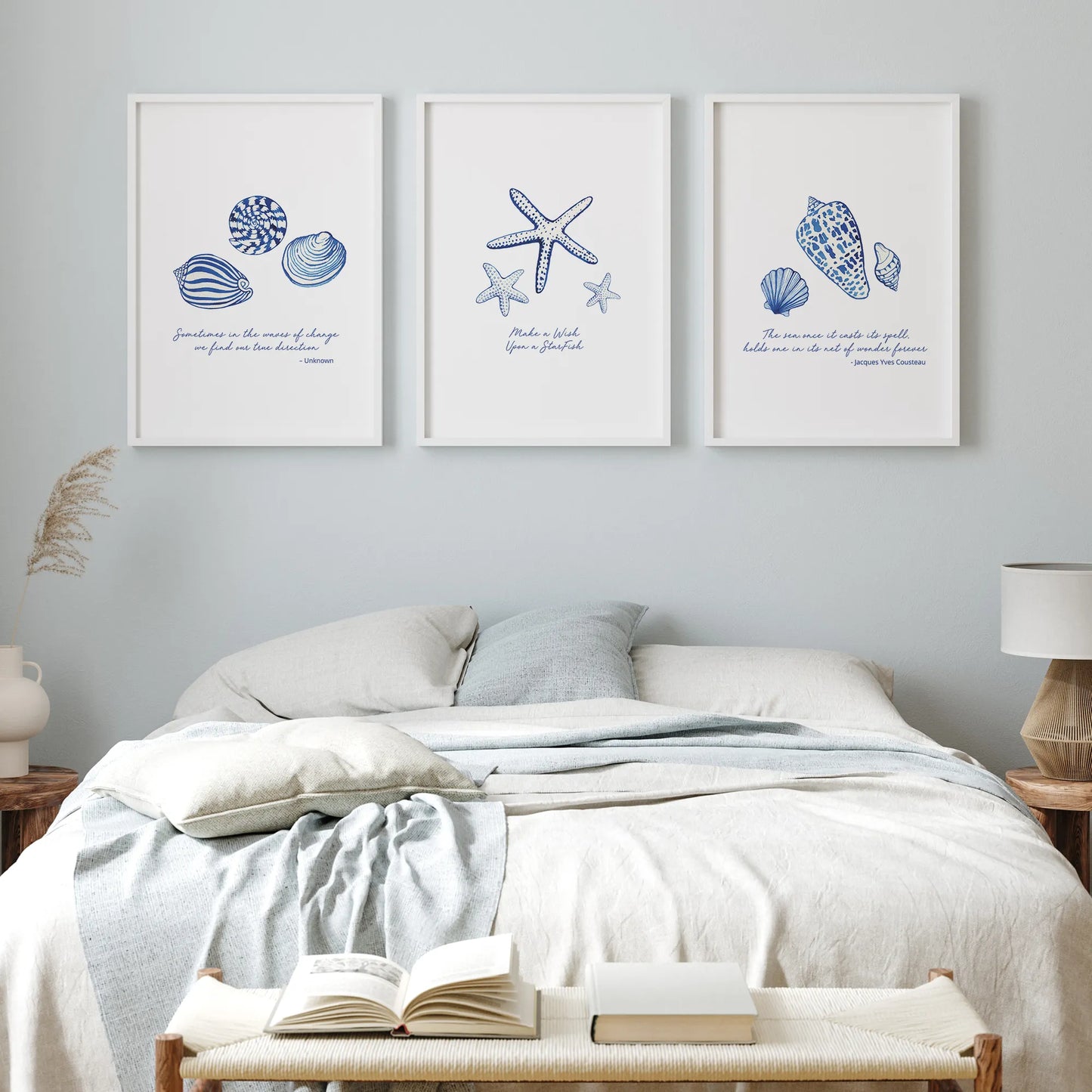 Coastal prints of blue seashells and starfish arranged in a modern bedroom, enhancing coastal decor.